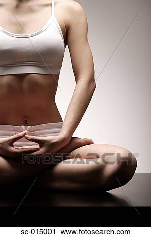Young Asian woman in lotus position View Large Photo Image Stock Image - Young Asian woman in lotus position. Fotosearch