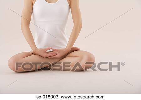 Young Asian woman in lotus position View Large Photo Image Stock Image - Young Asian woman in lotus position. Fotosearch