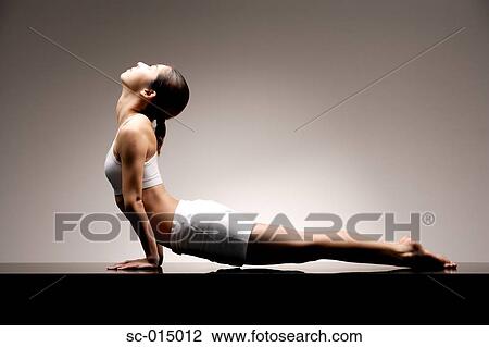 Stock Image - Young Asian woman in yoga position. Fotosearch
