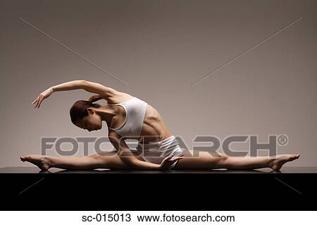 Stock Image - Young Asian woman in yoga position. Fotosearch