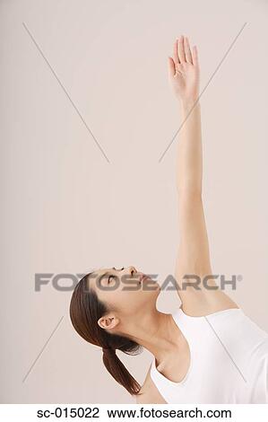 Stock Image - Young Asian woman in yoga position. Fotosearch