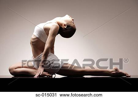 Young Asian woman in yoga position View Large Photo Image Stock Image - Young Asian woman in yoga position. Fotosearch