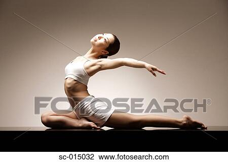 Stock Image - Young Asian woman in yoga position. Fotosearch