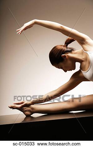 Stock Image - Young Asian woman in yoga position. Fotosearch