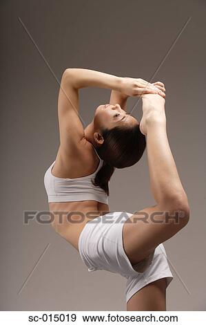 Stock Photo - Young Asian woman in yoga position. Fotosearch
