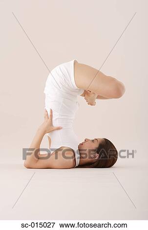 Stock Photo - Young Asian woman in yoga position. Fotosearch