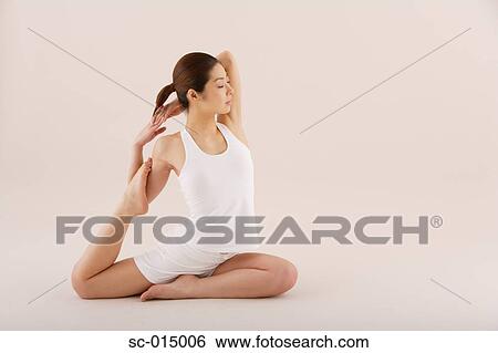 Young Asian woman in yoga position View Large Photo Image Stock Photograph - Young Asian woman in yoga position. Fotosearch