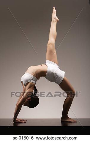 Stock Photograph - Young Asian woman in yoga position. Fotosearch