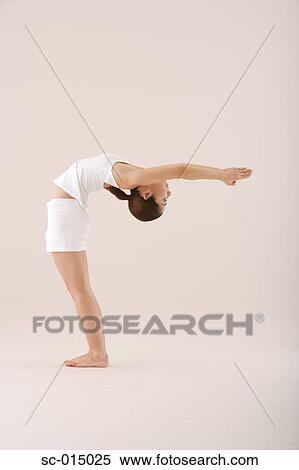 Stock Photography - Young Asian woman in yoga position. Fotosearch