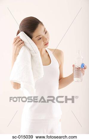 Young Asian woman relaxing after exercise View Large Photo Image Stock Photo - Young Asian woman relaxing after exercise. Fotosearch