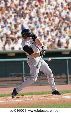 Stock Image - Baseball player hitting ball. Fotosearch