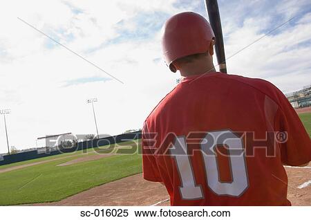Stock Photography - Baseball player looking into the feild. Fotosearch