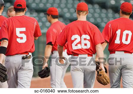 Stock Image - Baseball players walking back to the dugout. Fotosearch