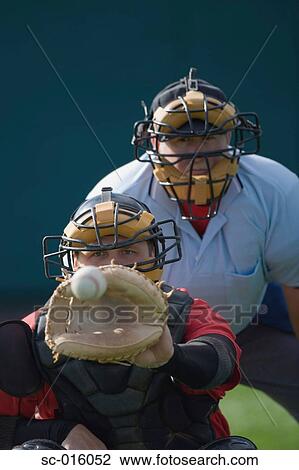 Stock Image - Catcher receiving a pitch. Fotosearch