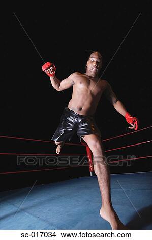 Picture - Mixed Martial Arts Fighter Kicking. Fotosearch