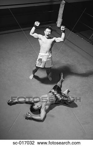 Stock Image - Mixed Martial Arts Fighter Knocked Down. Fotosearch