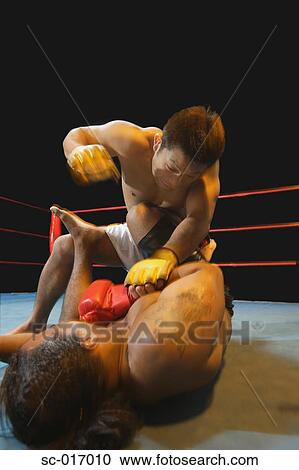 Stock Image - Mixed Martial Arts Fighter Punching. Fotosearch