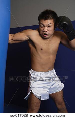 Stock Photo - Training on the heavy bag. Fotosearch