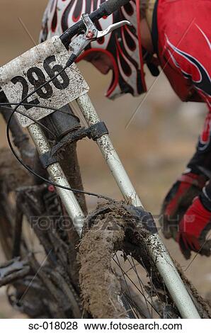 Mountain Biker Checking His Bike View Large Photo Image Stock Photo - Mountain Biker Checking His Bike. Fotosearch