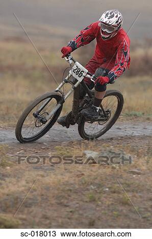 Stock Image - Mountain Biker Going Downhill. Fotosearch
