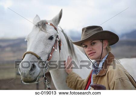 Stock Image - Cowgirl and her Horse. Fotosearch