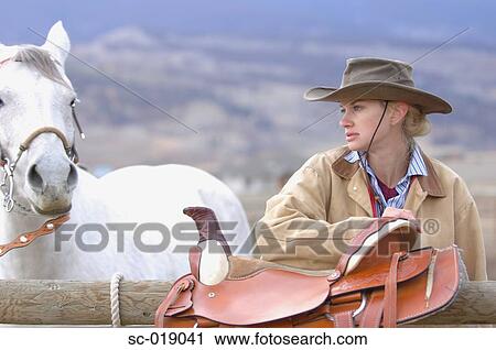 Stock Image - Cowgirl and her Horse. Fotosearch