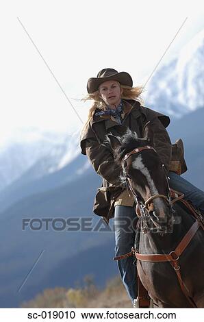 Stock Image - Cowgirl in the Countryside. Fotosearch