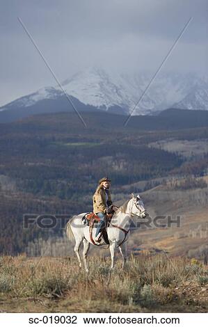 Stock Image - Cowgirl in the Countryside. Fotosearch