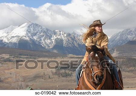 Stock Image - Cowgirl in the Countryside. Fotosearch