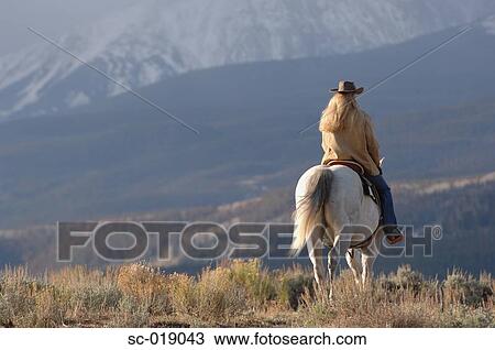 Stock Image - Cowgirl in the Countryside. Fotosearch