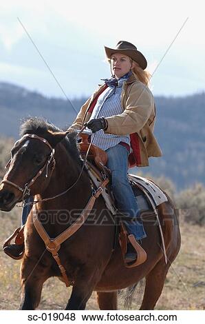 Stock Photo - Cowgirl On her Horse. Fotosearch