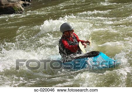 Stock Photograph - Kayaker Negotiating the River. Fotosearch