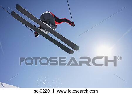 Stock Image - Skier Flying Through the Air. Fotosearch