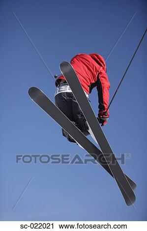 Stock Image - Skier Flying Through the Air. Fotosearch