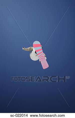 Picture - Snowboarder Flying Through the Air. Fotosearch