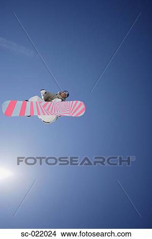 Picture - Snowboarder Flying Through the Air. Fotosearch