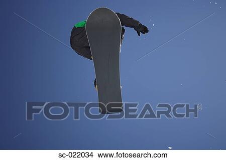 Picture - Snowboarder Flying Through the Air. Fotosearch
