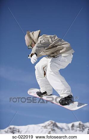Stock Photo - Snowboarder Flying Through the Air. Fotosearch