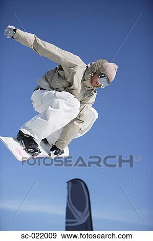 Snowboarder Juping a Barrier View Large Photo Image Stock Photo - Snowboarder Juping a Barrier. Fotosearch