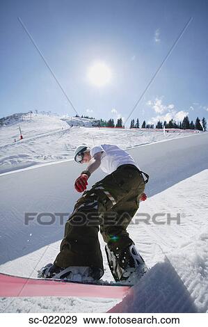 Stock Photo - Snowboarder Riding a Half-Pipe. Fotosearch