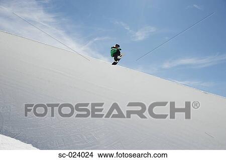 Picture - Snowboarder Riding a Half Pipe. Fotosearch