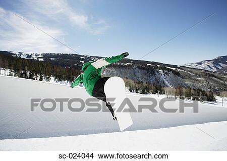 Picture - Snowboarder Riding a Half Pipe. Fotosearch