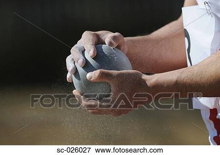 Stock Photo - Athlete Holding Metal Ball. Fotosearch