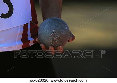 Stock Photograph - Athlete Holding Metal Ball. Fotosearch