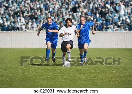 Soccer Player Dribbling Past Defenders View Large Photo Image Stock Image - Soccer Player Dribbling Past Defenders. Fotosearch