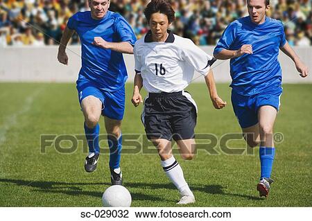 Soccer Player Dribbling Past Defenders View Large Photo Image Stock Image - Soccer Player Dribbling Past Defenders. Fotosearch