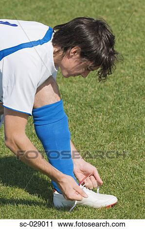 Soccer Player Tying His Boot View Large Photo Image Stock Image - Soccer Player Tying His Boot. Fotosearch