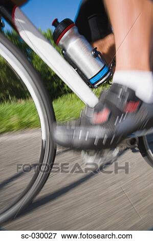 Stock Photo - Blurred motion of a cyclist pedaling. Fotosearch