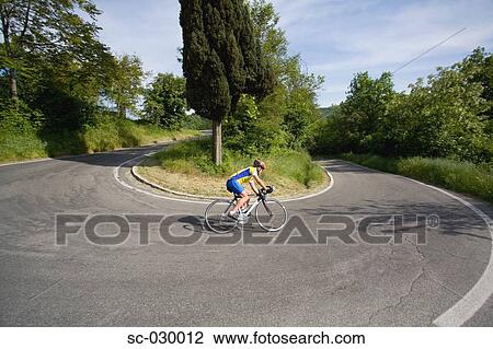 Cyclist cornering on switchback road, side view View Large Photo Image Stock Image - Cyclist cornering on switchback road, side view . Fotosearch