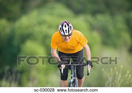 Cyclist riding bicycle, front, view View Large Photo Image Stock Photo - Cyclist riding bicycle, front, view. Fotosearch